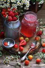 Strawberry cherry compote on a wooden table