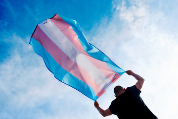 young person with a transgender pride flag