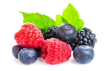 Healthy food berries set. Macro shot of fresh raspberries, blueberries and blackberries with leaf isolated on white background.