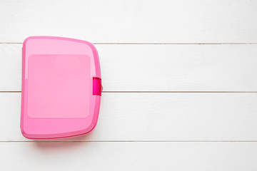 Plastic lunch box on white wooden background