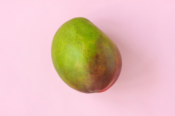 Ripe Green and Red Mango on pink pastel background. Styled Creative Image. Copy space, minimalistic style.