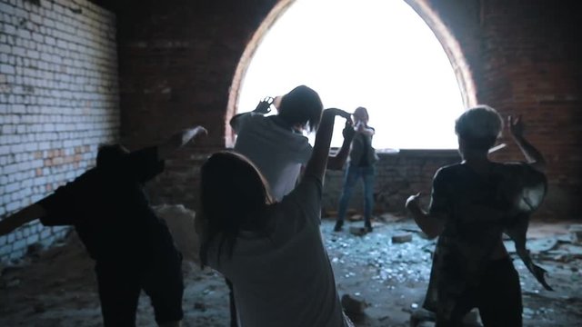 A zombie attack on the top floor of abandoned building. Survivors defend themselves