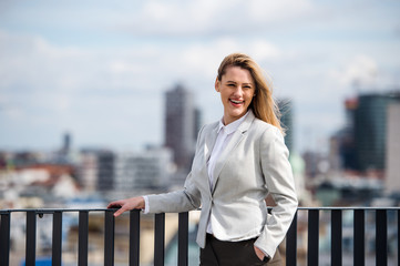 A portrait of young businesswoman standing outdoors. Copy space.