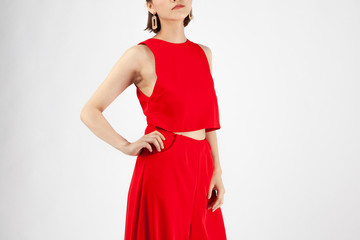 Asian Chinese Fashion influencer modeling in red Jumpsuit isolated in white background