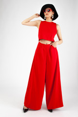 Asian Chinese Fashion influencer modeling in red Jumpsuit isolated in white background