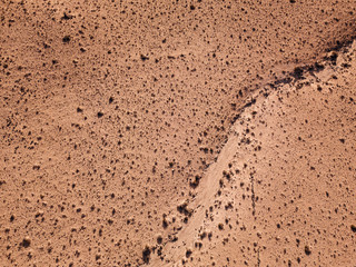 Aerial view of a desert landscape on the island of Lanzarote, Canary Islands, Spain. Desert background, texture. Sand and desolate land