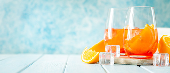 Aperol and ingredients drinks on wood background, copy space