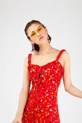 Asian Chinese Fashion influencer modeling in a red floral printed dress isolated in white background