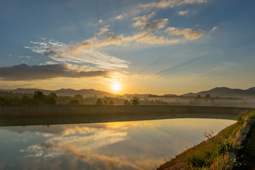 Fototapeta na wymiar Sunrise view At Ban Na Thong Suk Reservoir, Songkhla Province, Thailand