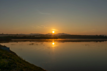 Blurry shot of photo sunrise over mountain at forest.