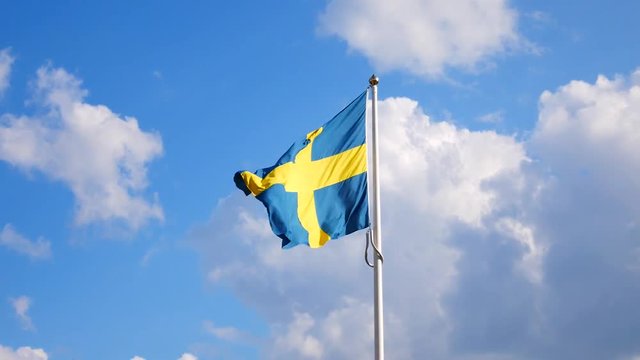 Swedish flag waving in the wind on a flagpole in Gothenburg, Sweden