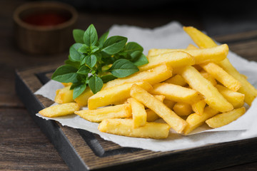 French fries on a wooden Board. Fast food. Fried potato
