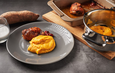 Served delicious mashed sweet potato with coconut milk and roasted chicken leg. Image represents healthy paleo eating, autoimmune disease treatment and is an example of a low carb keto diet