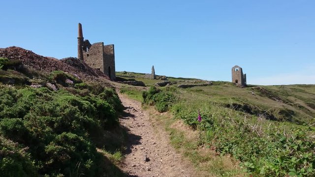 Poldark famous tin and copper mine location known as wheal leisure. The real name is wheal owles, world heritage site in the cornish countryside close to beautiful cliffs. Handheld Zoom out 4k footage