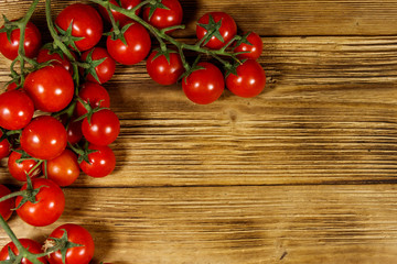 Fresh cherry tomatoes on a wooden table. Top view