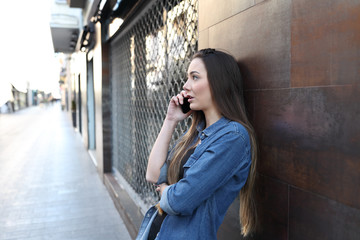 Woman talks on phone in the street