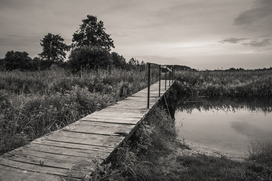 Footbridge over the river - black & white photography