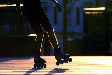 silhouette pairs of legs on roller skates