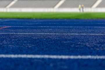 close up of blue tartan running track