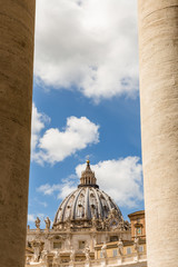 Saint Peter's Dome seen through the Bernini Colonnade in St. Peter's Square, Vatican City.