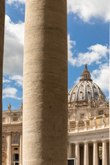 Saint Peter's Dome seen through the Bernini Colonnade in St. Peter's Square, Vatican City. Doric column detail.
