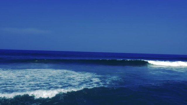 Aerial footage filmed with a drone overlooking the beach and sea of crashing waves with a deep blue ocean on the Bluff in Africa southern hemisphere.