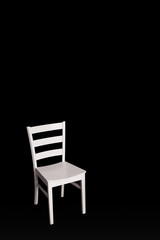 Modern white chair on black background.