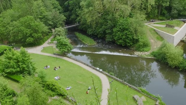 Tourists are enjoying the garden and sunny weather in the Grund, Luxembourg City in Luxembourg, Europe.