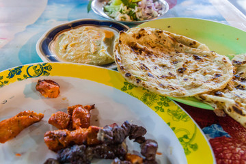 Grilled meat with hummus and bread at Al Husn Souq in Salalah, Oman