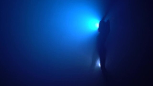 Woman dancing striptease video in the dark