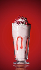 Pomegranate smoothie on red isolated background