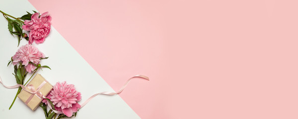 A bunch of peonies scattered around randomly with surprise gift boxes in boxes on a white background