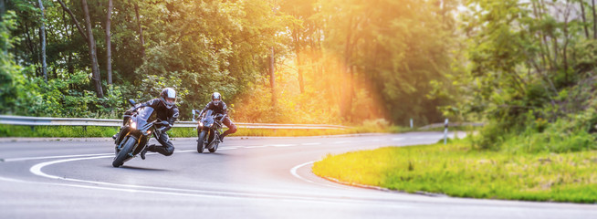 motorbike on the road riding. having fun riding the empty road on a motorcycle tour / journey - obrazy, fototapety, plakaty
