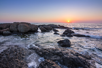 sunrise over the sea coast with rocks