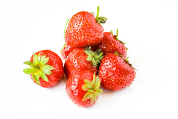 Red strawberries heap on white background view. Selective soft focus. Text copy space.