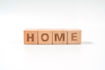 word HOME on wood cube dices on white background.