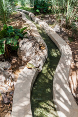 Traditional irrigation canal called Falaj in Wadi Tiwi valley, Oman