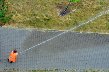 Watering green spaces on a hot summer day.