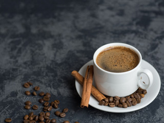White Cup of espresso coffee with cinnamon on the copyspace concrete table