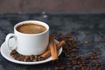 White Cup of espresso coffee with cinnamon on the copyspace concrete table