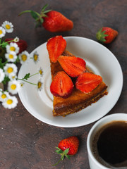 A Cup of espresso and strawberry pie on the table