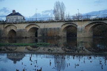 Fototapeta premium mirror reflection of old stone bridge in the river