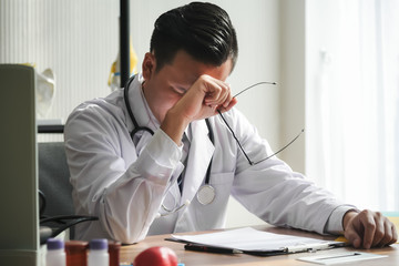 The doctor is stressed and tired from hard work to take care of patients, to health concept.