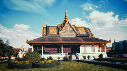 Fototapeta na wymiar The stunning Royal Palace architecture with a beautiful clear and dynamic blue sky, located at the city of Phnom Penh, Cambodia.