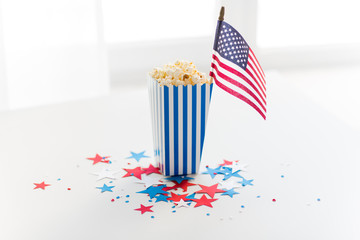 independence day, celebration and national holidays concept - close up of american flag, popcorn and stars confetti decoration at 4th july party