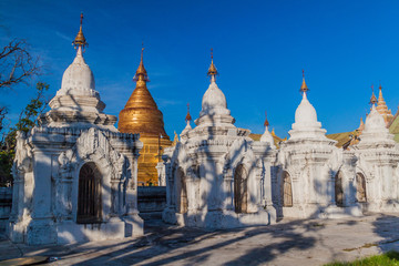 Fototapeta na wymiar White stupas around Kuthodaw pagoda in Mandalay, Myanmar