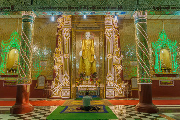 MANDALAY, MYANMAR - DECEMBER 4, 2016:  Interior of Kyauktawgyi temple in Mandalay, Myanmar