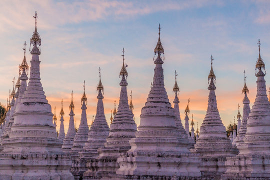 White stupas around Sandamuni (Sandamani or Sandar Mu Ni)  pagoda during dusk in Mandalay, Myanmar