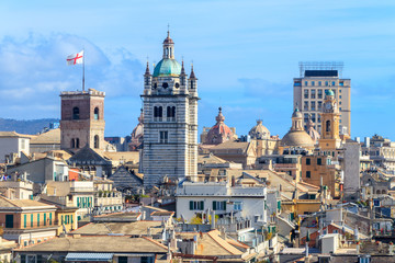Fototapeta na wymiar GENOA, ITALY - MARCH 9, 2019: The historic medieval center of Genoa - San Lorenzo Cathedral and a flag of Genoa