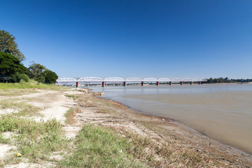 Fototapeta na wymiar Ava (Inwa) bridge crossing Irrawady (Ayeyarwady) river in Sagaing near Mandalay, Myanmar